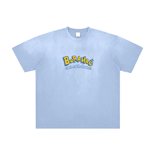 A light blue short-sleeve crewneck t-shirt with a colorful graphic on the chest reading 'Borahae' in yellow and blue with the tagline 'eat with all eyes!' underneath, displayed on a clean white background.