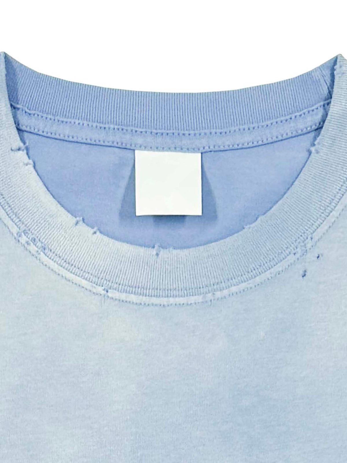 Close-up of a light blue shirt with a tag on a white background. hand frayed